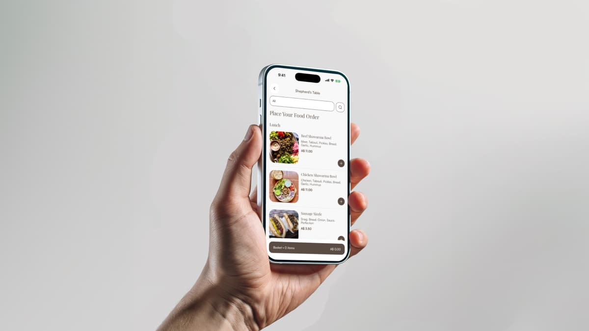 A hand holding a phone with the Shepherd's Table lunch menu open